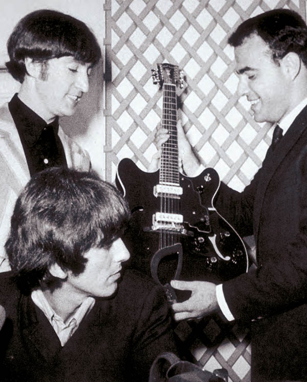 An Avnet/Guild vice president presents a Guild Starfire 12 to The Beatles