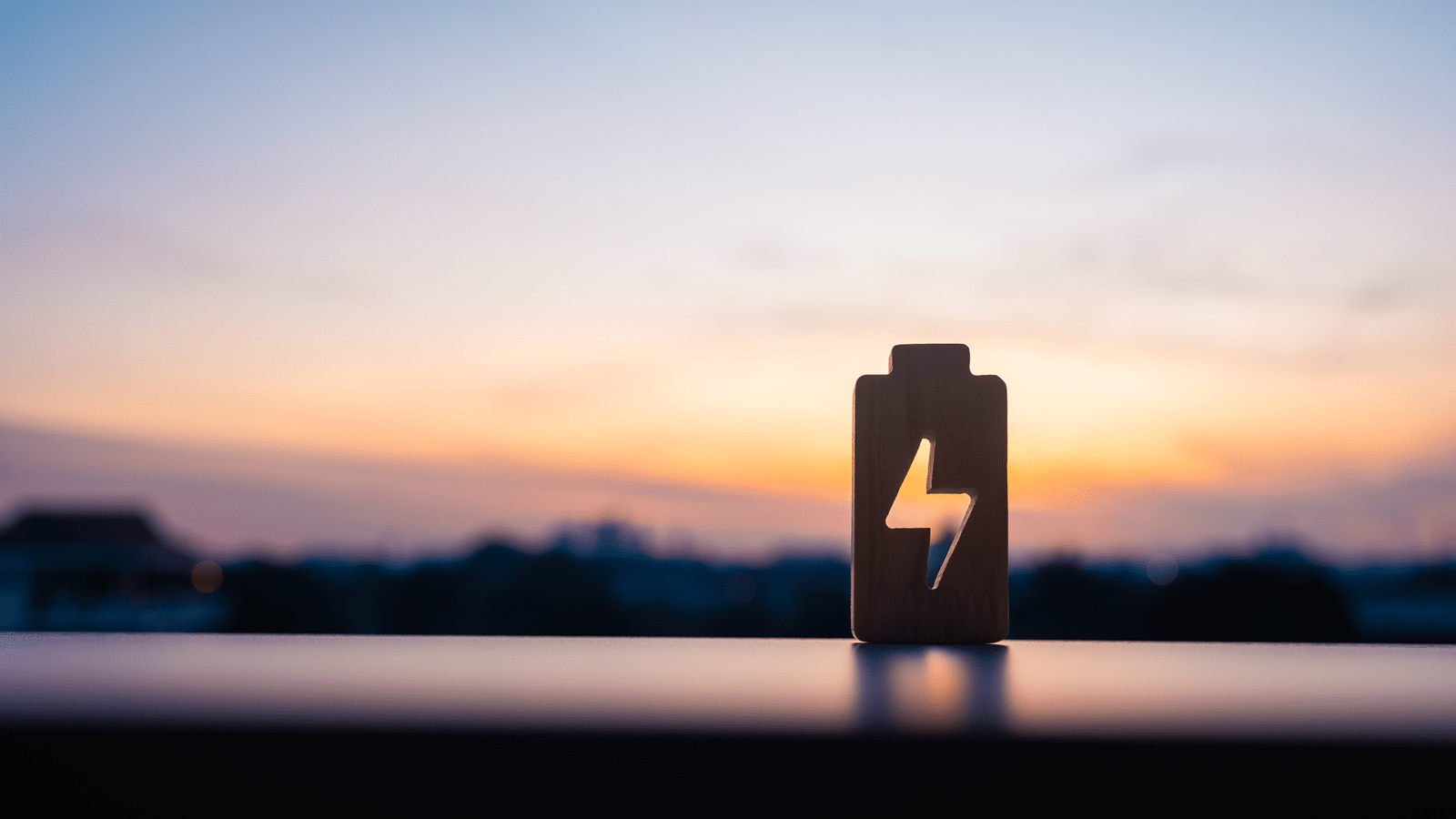 Wooden battery with a voltage symbol in middle to represent high voltage power electronics