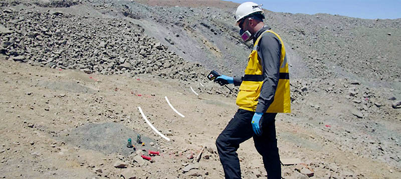 Employee using remote control electronic detonator in a mine