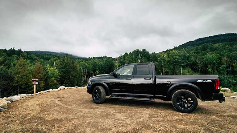 2019 Dodge Ram 1500 pick up truck parked on a hill in a forest