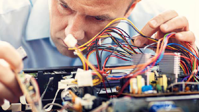 Engineer looks closely at embedded system