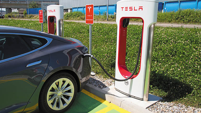 Tesla plugged into charging station